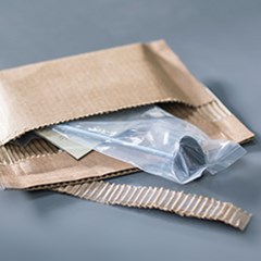 metal and plastic parts placed inside a cohesive mailerbox.